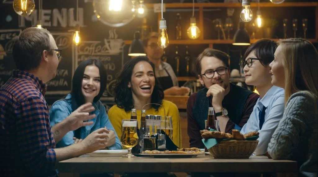 Diverse Group of Young People Have Fun in pub