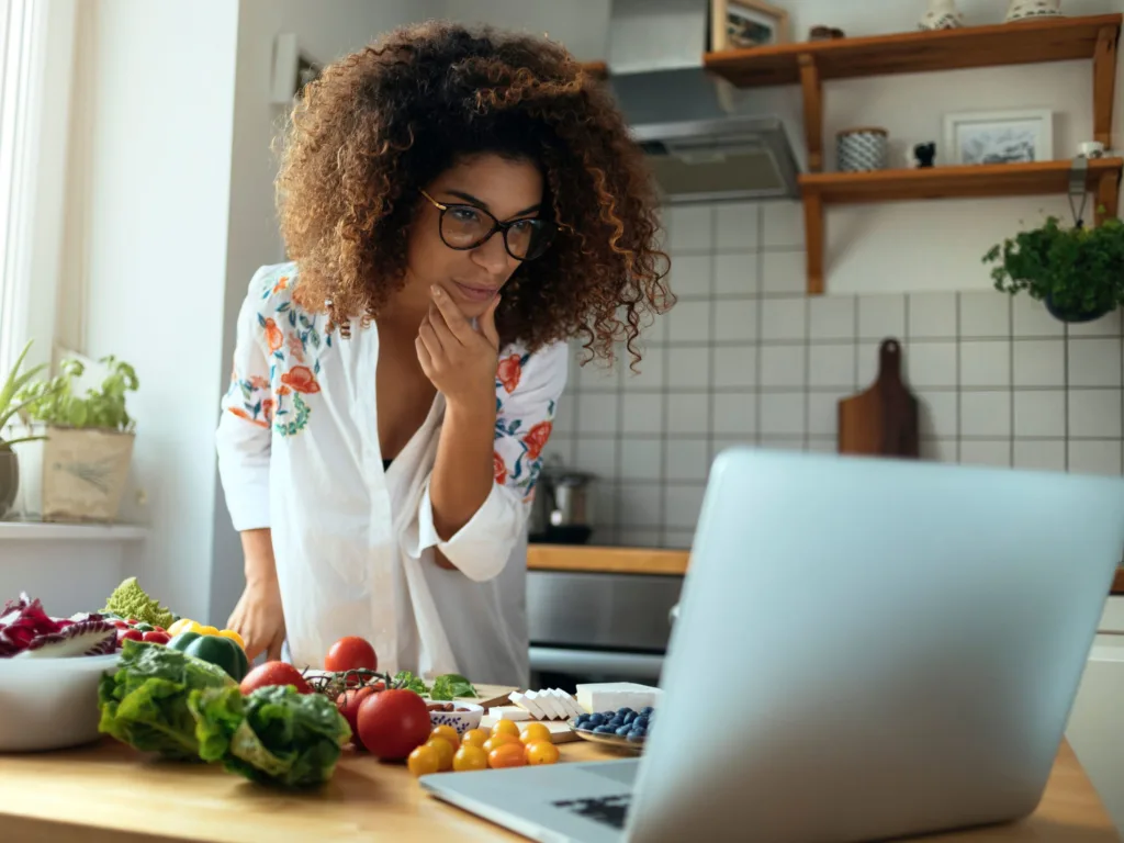 Women use laptop in the kitchen searching recipes and lifestyle cooking concepts